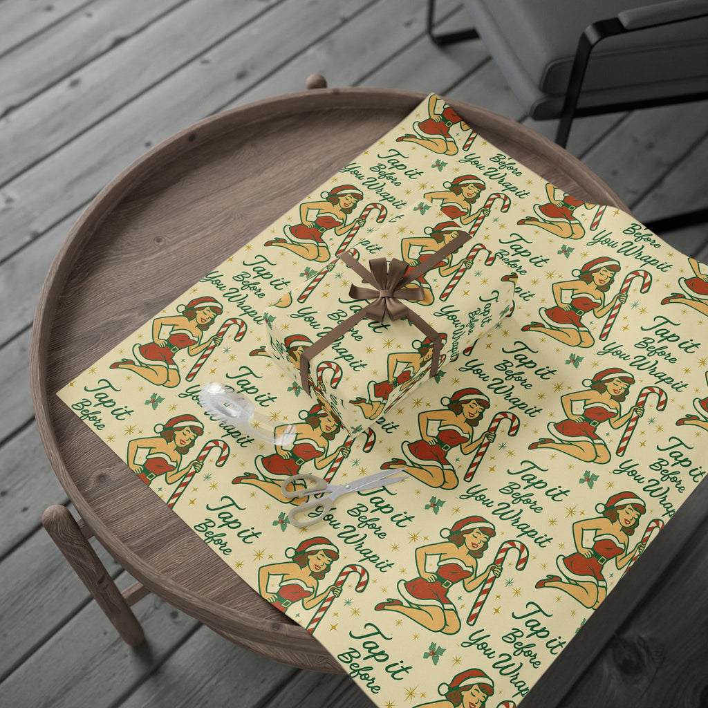 Retro holiday wrapping paper with red and green vintage print, laid flat for display