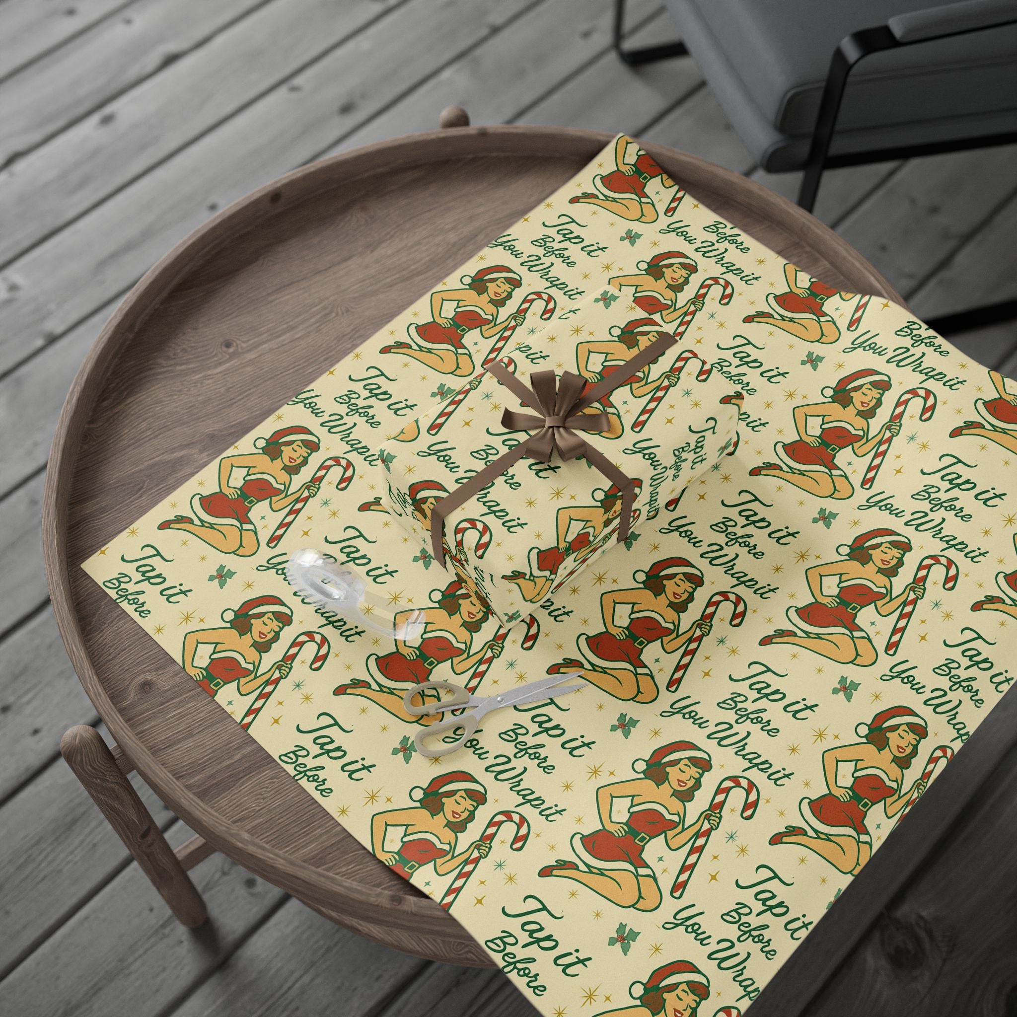 Retro holiday wrapping paper with red and green vintage print, laid flat for display
